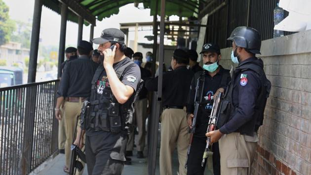 Police officers gather at an entry gate of district court following the killing of Tahir Naseem, who was accused of insulting Islam, in Peshawar, Pakistan, Wednesday, July 29, 2020.(AP)