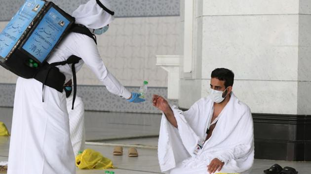 A pilgrim receives water at the Grand Mosque complex on July 29. Attendees this year have been given elaborate amenity kits that included sterilised pebbles for the ritual ‘Stoning of the Devil,’ disinfectant, masks and a prayer rug, according to the hajj ministry. Several health facilities, mobile clinics and ambulances are also on hand, AP reported quoting the ministry. (AFP) 