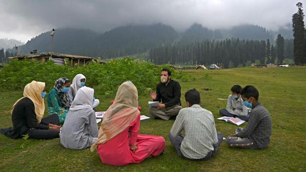 Students attend a class at an open-air school on top of a mountain in Doodhpathri, Jammu and Kashmir on July 27. Schooling in Kashmir has been severely disrupted due to the coronavirus (COVID-19) pandemic for several months now. (Tauseef Mustafa / AFP)