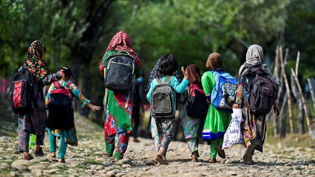 Children walk towards their open-air school in Doodhpathri on July 28. “I had thought my school was over for good and I would never meet my school friends again,” Shabnam, 12, who walks over a mile to the makeshift classroom, told AFP. (Tauseef Mustafa / AFP)