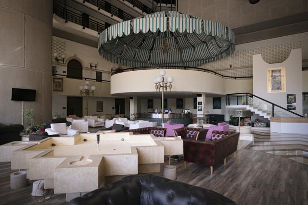 Staff members work at the bar of the Holiday Hotel, which opened as Holiday Inn, a luxurious accommodation for world's royalty, film stars and other dignitaries who came to watch the 1984 Winter Olympics, and less than a decade later, became ground zero of the bloody siege of Sarajevo in the 1990's, in Sarajevo, Bosnia, Wednesday, July 29, 2020. (AP)