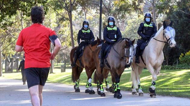 Police on horseback patrol the premises at the Shrine of Remembrance in Melbourne on July 31. Days after Australian authorities expressed hope that a Melbourne lockdown now in its third week was bringing persistent outbreaks under control, the surge is a potent warning that initial success in managing coronavirus can quickly unravel. (William West / AFP) Police on horseback patrol the premises at the Shrine of Remembrance in Melbourne on July 31. Days after Australian authorities expressed hope that a Melbourne lockdown now in its third week was bringing persistent outbreaks under control, the surge is a potent warning that initial success in managing coronavirus can quickly unravel. (William West / AFP)