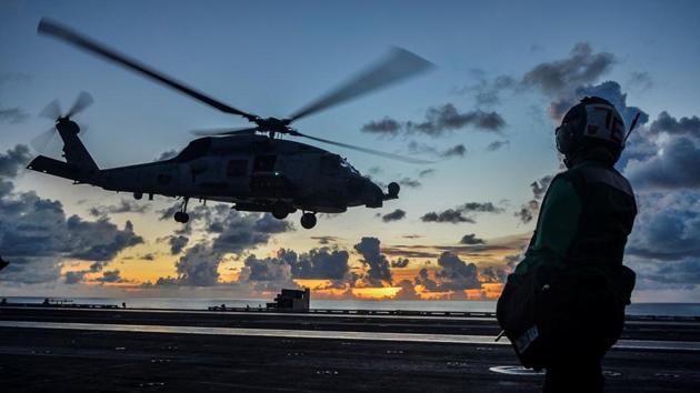 An MH-60R Sea Hawk helicopter launches during flight operations aboard the US Navy aircraft carrier USS Ronald Reagan in the South China Sea.(via REUTERS) An MH-60R Sea Hawk helicopter launches during flight operations aboard the US Navy aircraft carrier USS Ronald Reagan in the South China Sea.(via REUTERS)