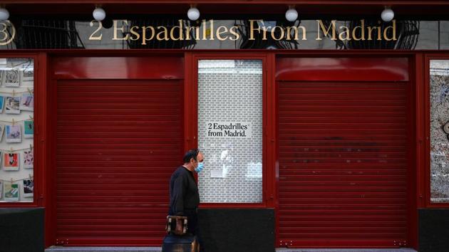 In this file photo taken on July 9, 2020 a man walks past a closed shop in Madrid. Spain’s economy has been the hardest hit in the 19-member eurozone due to the coronavirus pandemic.(AFP)