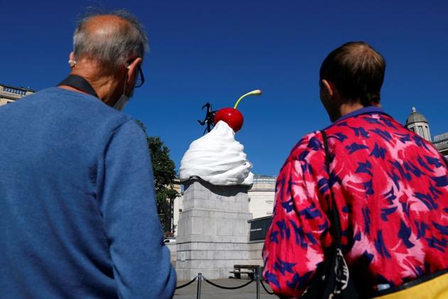 People look at Heather Phillipson's sculpture ''THE END'', after it was unveiled on Trafalgar Square's Fourth Plinth, in London, Britain, July 30, 2020. (REUTERS)