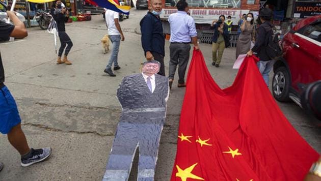 Members of the Tibetan Youth Congress drag a Chinese flag and a cutout of Chinese President Xi Jinping during a street protest calling for the boycott of Chinese goods in Dharmsala, India.(AP) Members of the Tibetan Youth Congress drag a Chinese flag and a cutout of Chinese President Xi Jinping during a street protest calling for the boycott of Chinese goods in Dharmsala, India.(AP)