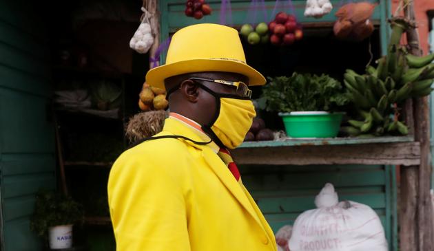 James Maina Mwangi walks along a street as he displays his attire comprising at least 160 suits with matching accessories including a mask to prevent the coronavirus disease (COVID-19) infection, near his residence in Nairobi, Kenya July 30, 2020. (REUTERS)