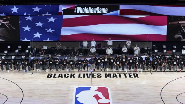 Members of the New Orleans Pelicans and Utah Jazz kneel together around the Black Lives Matter logo on the court during the national anthem before the start of an NBA basketball game.(USA TODAY Sports) Members of the New Orleans Pelicans and Utah Jazz kneel together around the Black Lives Matter logo on the court during the national anthem before the start of an NBA basketball game.(USA TODAY Sports)