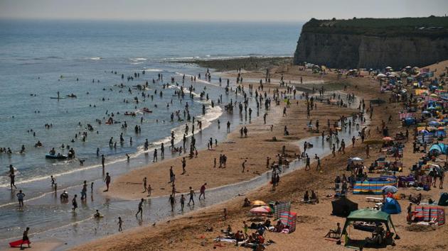 People enjoy the weather at the beach in Joss Gap Bay, amid the coronavirus disease (Covid-19) outbreak, in Broadstairs, Britain.(REUTERS) People enjoy the weather at the beach in Joss Gap Bay, amid the coronavirus disease (Covid-19) outbreak, in Broadstairs, Britain.(REUTERS)