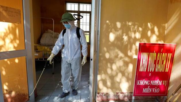 A health worker sprays disinfectants at a rapid testing center for coronavirus disease (Covid-19) outside Hanoi, Vietnam on July 30, 2020.(Reuters Photo) A health worker sprays disinfectants at a rapid testing center for coronavirus disease (Covid-19) outside Hanoi, Vietnam on July 30, 2020.(Reuters Photo)