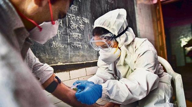 A health worker collecting a blood sample during the first round of the sero survey. (Sanchit Khanna/HT PHOTO) A health worker collecting a blood sample during the first round of the sero survey. (Sanchit Khanna/HT PHOTO)