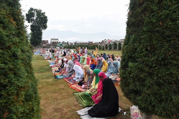 Kashmiri Muslim women offer Eid al-Adha prayers outside a shrine in Jinab Sahab Soura, in Srinagar, India on 01 August 2020. (Waseem Andrabi/ Hindustan Times)