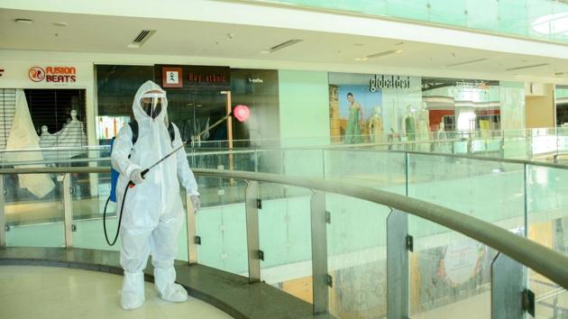 Worker wearing PPE kit sprays disinfectants to sanitise Westend Mall at Aundh in Pune, India, on Friday, July 31, 2020. (Milind Saurkar/HT Photo) Worker wearing PPE kit sprays disinfectants to sanitise Westend Mall at Aundh in Pune, India, on Friday, July 31, 2020. (Milind Saurkar/HT Photo)