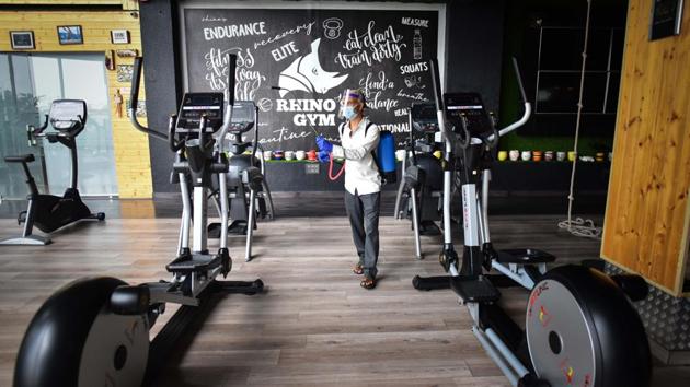 A worker chemically disinfects the premises inside a gym ahead of its reopening at Shalimar Bagh in New Delhi on July 31. The Centre announced on July 29 that gyms and yoga centres can reopen from August 5 under fresh relaxations, while also removing a night curfew that restricted movement of people outside containment zones. (Sanchit Khanna / HT Photo)