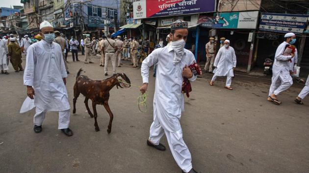 A man is seen with a goat after offering prayers on the occasion of Eid al-Adha in New Delhi on August 1. Just as other businesses, Covid-19 also hit livestock markets that spring up close to the festival. The economic downturn caused by the virus has curtailed people’s abilities to buy sacrificial animals in numbers that could match previous years. (Biplov Bhuyan / HT Photo)