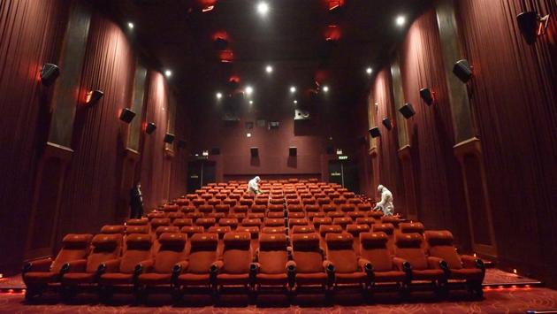 Health workers chemically disinfect the premises inside a cinema hall during a press preview to show preparedness of reopening halls amid the Covid-19 pandemic in New Delhi on July 31. Schools, colleges, theatres, swimming pools, metro rail, cinema halls and bars will continue to remain closed and large gatherings will also not be allowed, the Centre’s guidelines stated. (Sanjeev Verma / HT Photo)