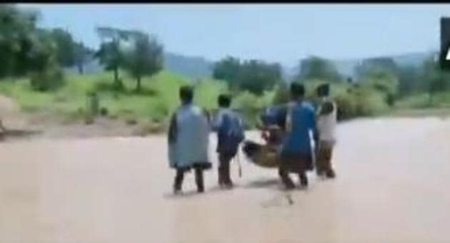 In a video, four men were seen carrying the women seated in a basket strung on a long lathi. (ANI screengrab) In a video, four men were seen carrying the women seated in a basket strung on a long lathi. (ANI screengrab)
