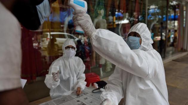 A BMC health care worker and doctors checks the temperature at Vile Parle market during Covid-19 pandemic in Mumbai, India, on Saturday, August 1, 2020. (Satish Bate/HT Photo) A BMC health care worker and doctors checks the temperature at Vile Parle market during Covid-19 pandemic in Mumbai, India, on Saturday, August 1, 2020. (Satish Bate/HT Photo)