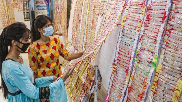 Women purchase 'rakhi' ahead of Raksha Bandhan festival at Sadar Bazaar, in Gurugram, Sunday, Aug. 2, 2020. (PTI)