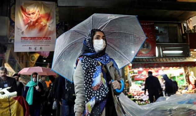 An Iranian woman wears a protective face mask and gloves, amid fear of coronavirus disease (Covid-19), as she walks at Tajrish market. (Reuters file photo) An Iranian woman wears a protective face mask and gloves, amid fear of coronavirus disease (Covid-19), as she walks at Tajrish market. (Reuters file photo)