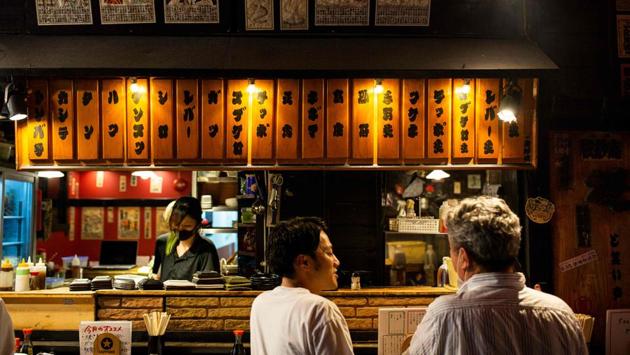 People eat at an ‘izakaya’, or Japanese-style bar, in Tokyo’s Shimbashi area on July 31. Infections first concentrated in Tokyo have spread to other urban areas, while regions without cases for months have become new hotspots. And the patient demographic -- originally younger people -- is expanding to the elderly, a concern for a country with the world’s oldest population, Bloomberg reported. (Behrouz Mehri / AFP) People eat at an ‘izakaya’, or Japanese-style bar, in Tokyo’s Shimbashi area on July 31. Infections first concentrated in Tokyo have spread to other urban areas, while regions without cases for months have become new hotspots. And the patient demographic -- originally younger people -- is expanding to the elderly, a concern for a country with the world’s oldest population, Bloomberg reported. (Behrouz Mehri / AFP)