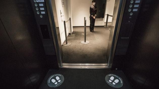 Social distancing markers are displayed on an elevator in the Roppongi district of Tokyo on July 30. The national government continues to argue that the situation this time is different. Chief Cabinet Secretary Yoshihide Suga reiterated July 31 that another state of emergency isn’t required. The death rate in Japan remains low and country has fewer than 100 people in critical care due to Covid-19. (Shoko Takayasu / Bloomberg) Social distancing markers are displayed on an elevator in the Roppongi district of Tokyo on July 30. The national government continues to argue that the situation this time is different. Chief Cabinet Secretary Yoshihide Suga reiterated July 31 that another state of emergency isn’t required. The death rate in Japan remains low and country has fewer than 100 people in critical care due to Covid-19. (Shoko Takayasu / Bloomberg)