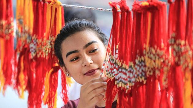 A young woman buys rakhi from a shop ahead of the Raksha Bandhan festival, in Bathinda, Sunday, Aug 2, 2020. (PTI)