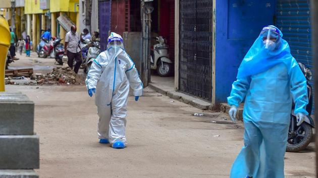 Medics wearing PPE kits arrive to conduct COVID-19 Rapid Antigen test at Kalasipalyam during a week lockdown imposed due to surge in coronavirus cases, in Bengaluru. (PTI) Medics wearing PPE kits arrive to conduct COVID-19 Rapid Antigen test at Kalasipalyam during a week lockdown imposed due to surge in coronavirus cases, in Bengaluru. (PTI)
