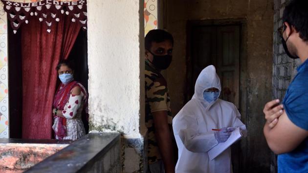 A BMC health care worker checks on a resident at Kurla in Mumbai in August 2. With 803 new deaths, the COVID-19 disease has now killed 38,938 people in India. Meanwhile recoveries have increased to 12,30,509. On August 2, Union Home Minster Amit Shah tested positive for Covid-19 as well. (Satish Bate / HT Photo)