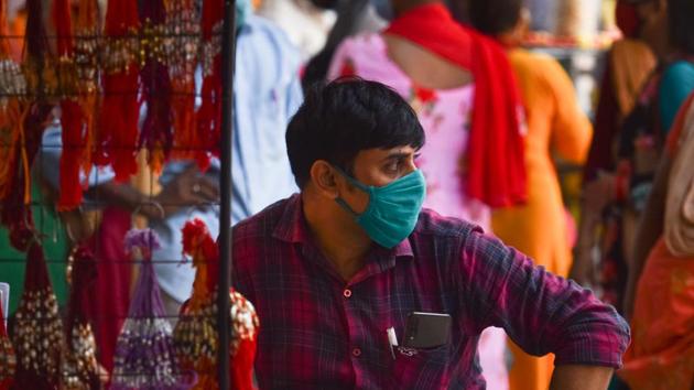 A vendor wearing a face mask while selling rakhis ahead of Rakshabandhan festival, at Sadar Bazar, in New Delhi. (Sanchit Khanna/HT PHOTO) A vendor wearing a face mask while selling rakhis ahead of Rakshabandhan festival, at Sadar Bazar, in New Delhi. (Sanchit Khanna/HT PHOTO)