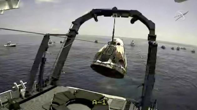 The Crew Dragon capsule is lifted out of water off Pensacola coast in Florida on August 2. The capsule splashed into the water off Pensacola at 2:48 pm (18:48 GMT) in a first water landing for a crewed US spaceship since the 1975 Apollo-Soyuz mission. (NASA via REUTERS)