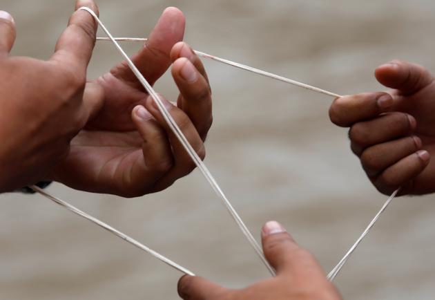 Hands of devotees are pictured as they arrange a sacred thread during the Janai Purnima festival (Sacred Thread Festival) at Pashupatinath Temple in Kathmandu, Nepal, August 3, 2020. (REUTERS)