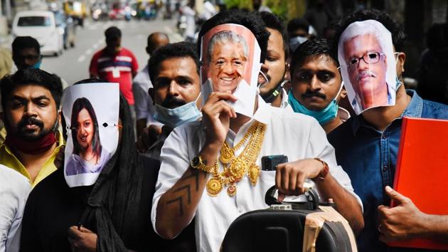 Youth Congress activists hold pictures of Kerala Chief Minister Pinarayi Vijayan (C), former UAE consulate officer Swapna Suresh (L), and State IT Secretary M Sivasankar (R) during a protest over the Kerala gold smuggling case in Kochi. (PTI FILE PHOTO) Youth Congress activists hold pictures of Kerala Chief Minister Pinarayi Vijayan (C), former UAE consulate officer Swapna Suresh (L), and State IT Secretary M Sivasankar (R) during a protest over the Kerala gold smuggling case in Kochi. (PTI FILE PHOTO)