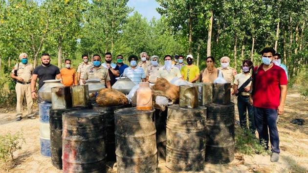 The police team with the recovered lahan near the banks of Sutlej river in Ludhiana on Monday. (HT Photo) The police team with the recovered lahan near the banks of Sutlej river in Ludhiana on Monday. (HT Photo)