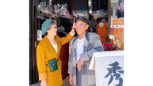 Chang Wan-ji (R) and his wife Hsu Sho-er pose for photographs at their laundry store in Taichung, Taiwan in a photo released on August 1. Taiwan's trendiest couple these days are neither young celebrities nor teen influencers -- they are an octogenarian duo who run a mom-and-pop laundry service and have become an online sensation by modelling abandoned clothes. (Reef Chang / AFP)