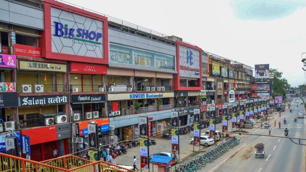 Shopkeepers stand outside their closed shops at a shopping complex in Ranchi. (PTI) Shopkeepers stand outside their closed shops at a shopping complex in Ranchi. (PTI)