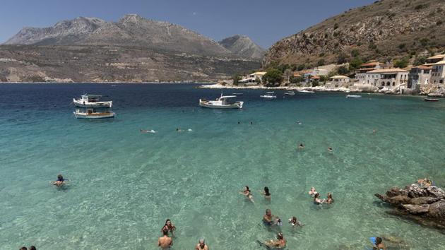 Tourists enjoy the sea at Limeni village of Mani peninsula, Peloponnese region, Greece on July 31, 2020.(Bloomberg)