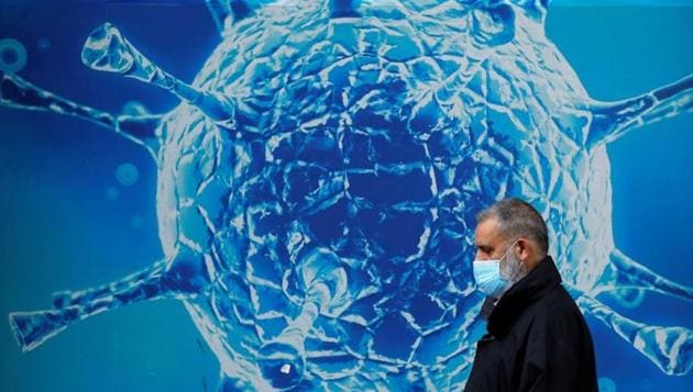 A man wearing a protective face mask walks past an illustration of a virus outside a regional science centre, as the city and surrounding areas face local restrictions in an effort to avoid a local lockdown being forced upon the region, amid the coronavirus disease (COVID-19) outbreak, in Oldham, Britain August 3, 2020. (Representational)(REUTERS) A man wearing a protective face mask walks past an illustration of a virus outside a regional science centre, as the city and surrounding areas face local restrictions in an effort to avoid a local lockdown being forced upon the region, amid the coronavirus disease (COVID-19) outbreak, in Oldham, Britain August 3, 2020. (Representational)(REUTERS)