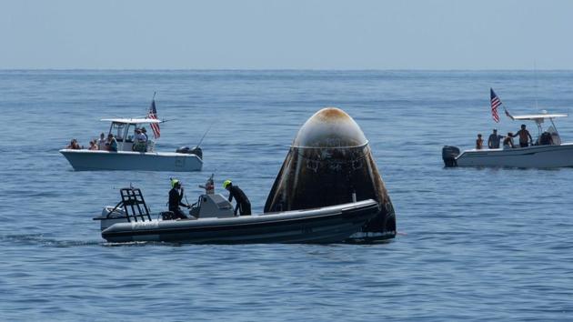 Support teams and curious recreational boaters arrive at the SpaceX Crew Dragon Endeavour spacecraft shortly after it landed off Pensacola coast in Florida on August 2. President Donald Trump had travelled to Florida two months ago to attend the launch of the mission to the ISS. (Bill Ingalls / NASA / AFP)