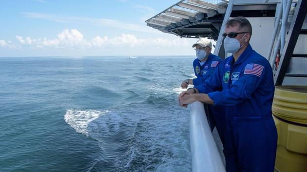 NASA Chief Astronaut Pat Forrester (L) and NASA Crew Recovery Chief Shane Kimbrough look at the landing as their teams prepare for the astronauts’ exit from the spacecraft. The mission is also a huge win for Elon Musk’s SpaceX, which was founded in only 2002 but has leap-frogged its way past Boeing, its main competitor in the commercial space race, AFP reported. (Bill Ingalls / NASA / AFP)