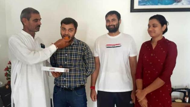Pradeep Singh (in shirt) celebrates with his family at his residence in Sonepat on Tuesday. (Manoj Dhaka/HT) Pradeep Singh (in shirt) celebrates with his family at his residence in Sonepat on Tuesday. (Manoj Dhaka/HT)