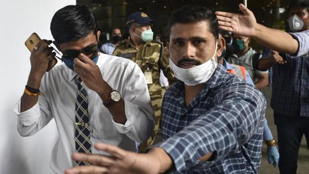 IPS officer Vinay Tiwari (in white shirt) arrives at Mumbai airport on Monday to probe actor Sushant Singh Rajput's death case.(Satyabrata Tripathy/HT Photo)