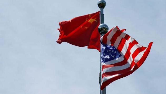 Chinese and US flags flutter before a trade meeting in Shanghai, China. The virus was first detected in the central Chinese city of Wuhan late last year and has been linked to a wholesale food market where wild animals were sold.(REUTERS)