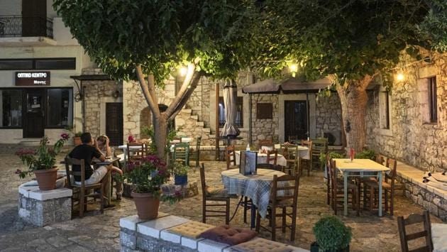 A couple sits in a tavern in the town of Areopoli on the Mani Peninsula, Laconia, Peloponnese region, Greece, on Wednesday July 29, 2020. (Konstantinos Tsakalidis/Bloomberg) A couple sits in a tavern in the town of Areopoli on the Mani Peninsula, Laconia, Peloponnese region, Greece, on Wednesday July 29, 2020. (Konstantinos Tsakalidis/Bloomberg)