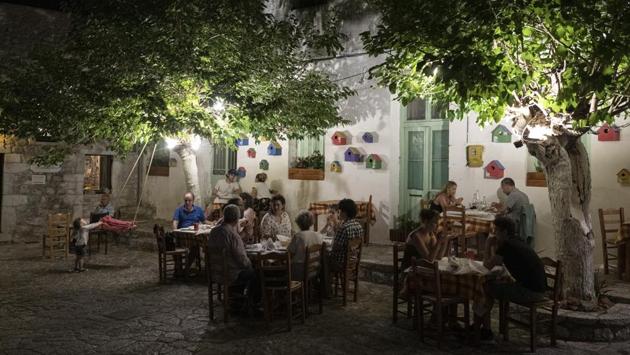 Tourists and local residents sit outside a tavern in the town of Areopoli on the Mani Peninsula, Laconia, Peloponnese region, Greece on July 29, 2020. (Konstantinos Tsakalidis/Bloomberg) Tourists and local residents sit outside a tavern in the town of Areopoli on the Mani Peninsula, Laconia, Peloponnese region, Greece on July 29, 2020. (Konstantinos Tsakalidis/Bloomberg)