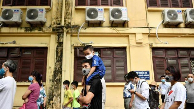 People observe social distancing while waiting to be tested at a makeshift rapid testing centre in Hanoi on August 1. The Southeast Asian country of 96 million has confirmed at least 652 infections, with eight deaths as of August 4. (Manan Vatsyayana / AFP) People observe social distancing while waiting to be tested at a makeshift rapid testing centre in Hanoi on August 1. The Southeast Asian country of 96 million has confirmed at least 652 infections, with eight deaths as of August 4. (Manan Vatsyayana / AFP)
