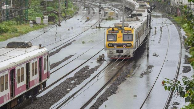 Trains stationed on waterlogged tracks between Matunga and Mahim railway stations after heavy rain, in Mumbai on August 4. Local train services, which are currently being operated only for those engaged in essential services, were suspended on some routes in Mumbai and suburbs due to water-logging on rail tracks. (PTI)