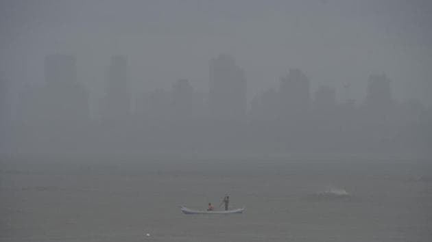 Fishermen row their boat amid rains in the Arabian Sea, in Mumbai. (PTI) Fishermen row their boat amid rains in the Arabian Sea, in Mumbai. (PTI)