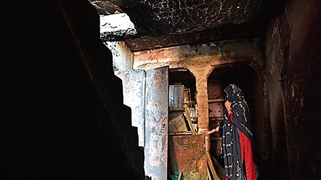 A woman stands in a burnt house in north-east Delhi. Police are probing the communal riots in February. (HT Archive) A woman stands in a burnt house in north-east Delhi. Police are probing the communal riots in February. (HT Archive)