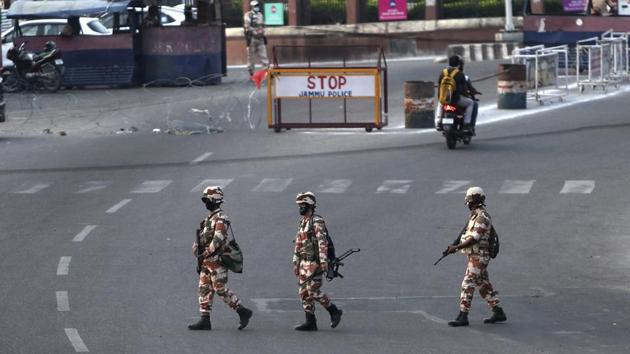 Paramilitary soldiers patrol a road in Jammu on Tuesday, the eve of the first anniversary of the abrogation of Article 370. (AP Photo) Paramilitary soldiers patrol a road in Jammu on Tuesday, the eve of the first anniversary of the abrogation of Article 370. (AP Photo)